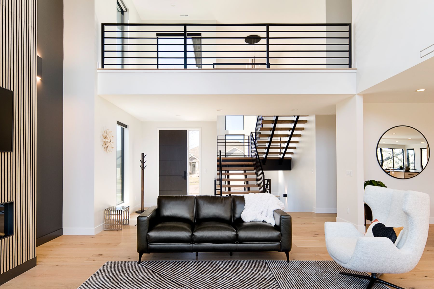 View through the great room to the open staircase and loft rail