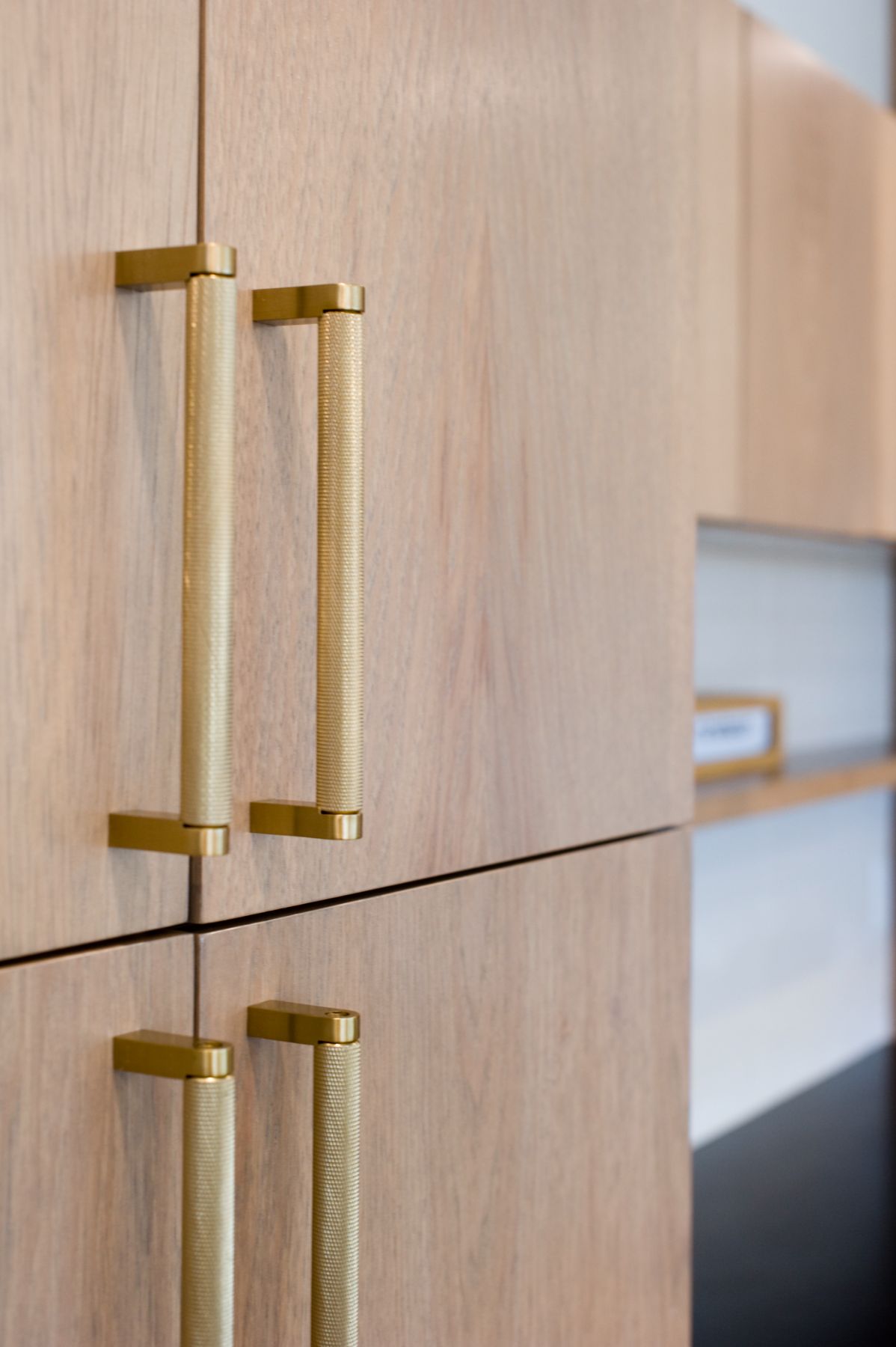 Brass pulls on white oak cabinet doors